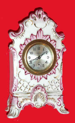 Mixed lot: C.1900 Ansonia 30-hour movement in a nice German miniature porcelain case, — Antique Clocks Price Guide