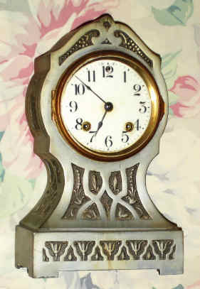 C.1911, Ansonia Clock Co., NY, "THEBES", cast iron mantel clock, with Art Nouveau designs cast into the metal, finished in Pewter. — Antique Clocks Price Guide