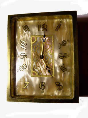 Art Deco Perfume Bottle Clock by Juvenia- "Le Numero 7 de Juvenia" in gilt and onyx case with Mother-of-Pearl multicolor AN dial, signed Dore Didisheim Goldschmidts Swiss, 3.75"H x 2.5"W. — Antique Clocks Price Guide