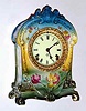 C.1904, Ansonia, Royal Bonn, "La Cruz" porcelain china clock, in a tri-color case starting at dark aqua to top down to yellow in the center, and green at the base. With solid porcelain dial. See 1998 Ansonia book page 632, fig 2687, 2004 price guide = $500.