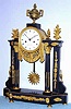 C.1830, French, Mathieu, a' Rouen, Empire Style Portico clock, black marble and ormolu, and with a large round movement with silk thread suspension.