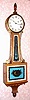 C.1965, English, Biddle and Mumford, a banjo clock made with imported glasses, dial and pendulum (from the US) and a quality weight movement.