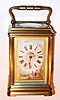 C.1900, French, Brass Cased Carriage clock, time and strike, in a cannelee case, the dial a porcelain plaque with a city river scene in the bottom showing a mother and child, hand painted, with a gilt border.