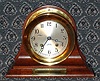 C.1991, Chelsea Clock Co., Boston, CHELSEA model 4.5" ships bell clock on mahogany stand, serial No. 876366, with presentation plaque, hinged bezel, button latch.