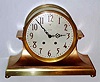 C.1913, Seth Thomas Clock Co., "COLOSSAL", metal cased mantel clock, same design as the Celtic, only larger. Base is cast bronze and the cylinder, bezel and rear cover are brass, and the outer body is cast white metal, bronzed. Silvered dial with raised bronze numerals.