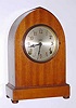 C.1930, E. Ingraham and Co., Rounded Gothic Shelf Clock, 8-day time and gong strike with half hour bell, dial with raised numerals.