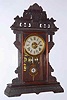 C.1885, E. N. Welch Mfg. Co., ECLIPSE, walnut parlor clock with fancy cast pendulum with sandwich glass center.