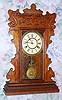 C.1900, New Haven Clock Co., "Patrol Line", 8-day time/strike gingerbread mantel clock.
