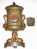 C.1810, Austrian, Carved and Patinated Wood clock case in the form of an Urn, now with a Grand Sonnerie movement from the same period, the proper size, but will require a dial and dial feet.