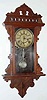C.1891, Waterbury Clock Co., "Lawrence", 8-day time and gong strike hanging gingerbread clock, with restored top.