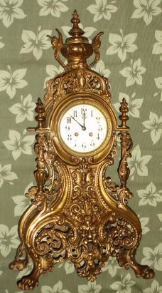 French, Mougin, Large cast bronze fantasy clock, depicting the North Wind at the bottom, other gargoyles and winged griffins aside the top finial, and with 4 large paw feet, with a quality bell strike movement and porcelain dial. C. 1890. — Antique Clocks Price Guide
