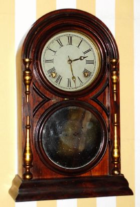 Atkins Clock Company, Bristol, Conn. Patented August 13th 1867, Victor Round Top No. 3, 8-day time and strike brass mvt in rosewood veneered case with gilded split columns on the sides and mirror tablet shelf clock, spring driven. C.1873. — Antique Clocks Price Guide