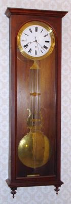 New York, Wall hanging Jeweler's regulator, walnut case, with lyre pendulum engraved: "EST'D 1860, M. L. SHEEHAN, 785 8TH AVE, N.Y". This clock hung at the base of Mr. Goddard's stairs since 1970, and the foto was taken in place at his home in June 2009. C.1890. — Antique Clocks Price Guide