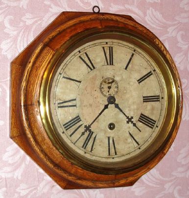 Waterbury Clock Co., "8 INCH LEVER", octagonal wall timepiece in a segmented and turned oak case, 8-day, spring. C.1890. — Antique Clocks Price Guide