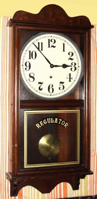 New Haven, New Haven Conn, "REFEREE" model, 8 day time only brass mvt in poplar case with walnut stain and 12" paper over zinc dial, spring driven. C. 1925. — Antique Clocks Price Guide