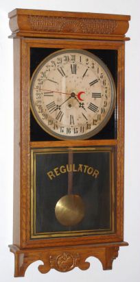 E. Ingraham and Co, Bristol Conn, "WESTERN UNION" calendar model, 8 day time brass mvt store regulator in solid oak case with 12" dial, spring driven. C. 1907. — Antique Clocks Price Guide