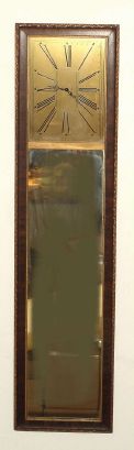 Waltham, Waltham Mass, Mirror clock with 8 day car clock movement, stem wind at the side, in imitation rosewood grain case with gilded foliate trim and 11"H x 8 3/4"W metal Art Deco style dial set above looking glass. C. 1925. — Antique Clocks Price Guide