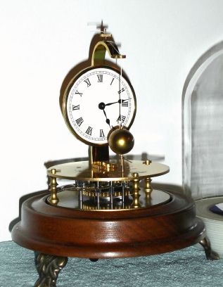 Horolovar Co., NY (Charles Terwilliger), repro of the famous Briggs rotary pendulum clock, 8-day, time, bottom wind, with glass dome. C.1975. — Antique Clocks Price Guide