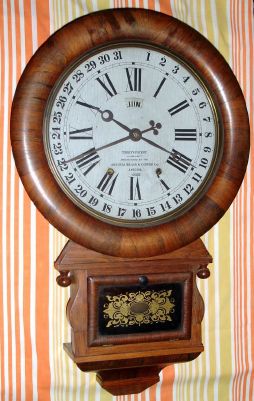 Ansonia Brass and Copper Co, Ansonia, Conn. "DROP EXTRA CALENDAR" model, 8 day time brass mvt in rosewood veneered case with 12" dial with aperture for month and indicator hand for date marked "TERRY'S PATENT. MANUFACTURED BY THE ANSONIA BRASS and CPPER CO. ANSONIA. CONN.", spring driven. C. 1883. — Antique Clocks Price Guide