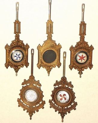 Pendulums, lot of 5 (five), Welch cast pends: two for Eclipse, and 2 for Pattis, first 4 with sandwich glass inserts, and a 5th with a hard rubber insert, with ENWCo logo molded in. C.1880. — Antique Clocks Price Guide