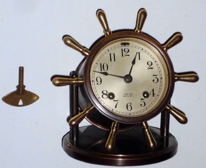 Chelsea Clock Co., Boston, Mass, "VANDERBILT", Ship's Bell desk clock in bronze finish with yellow brass handles, 8-day, spring. C.1950. — Antique Clocks Price Guide