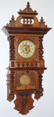 German, Kienzle, open well Berlin style free swinger, in a walnut case, gong strike 8-day, spring. C.1900. — Antique Clocks Price Guide