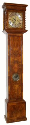 English, Martin Ellwood, Londini Fecit, uncommon and desirable 10 inch brass dial quarter striking movement, 8-day, in an attractive, well proportioned, purpose made tall case with book matched burled walnut veneer, cross banded panels on the sides, and barley twist columns to the hood. The large and robust movement has finely turned baluster pillars, count wheel on the rear plate (cut to strike the quarter hours) on two bells, the hours on a single bell. This is an unusual feature not commonly found on clocks of this period. The dial features a calendar aperture at 6, exquisitely matted center with finely ringed winding holes, a seconds ring and finely pierced hands of the period. C.1690. — Antique Clocks Price Guide