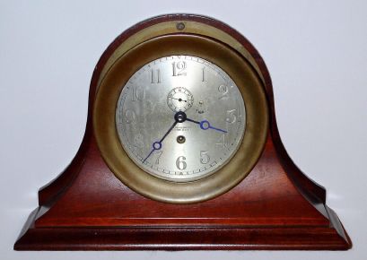 Chelsea Clock Co., Engine Room timepiece with 6 inch dial in a yellow brass case with screw bezel, serial No. 179165. With a C. 1980 Chesea factory desk stand, mahogany. C.1927. — Antique Clocks Price Guide