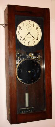 International Business Machine Co., (ITR Div), Endicott, NY, Fully programmable master clock, self winding, model 15-7, in a walnut finished case. C.1940 — Antique Clocks Price Guide