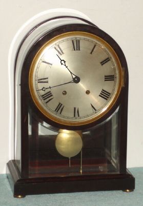 German, M. Winterhalder and Hofmeier, Neustadt, Baden, unusual mahogany and beveled glass quarter striking regulator, with silvered dial and neat curved glass that continues clear around the top. 8-day. C.1900 — Antique Clocks Price Guide