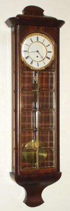 A Vienna Regulator timepiece from the Biedermeier era, updated to 20th century style with the addition of beveled glass to the front and sides. — Antique Clocks Price Guide