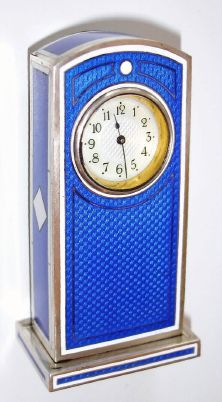 Swiss, miniature mantel clock, Royal Blue guilloche enamel over hallmarked silver, and with contrasting white strips and a white diamond shaped inset on each side, with rear wind and set lever movement, C.1935 — Antique Clocks Price Guide