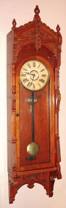 F. Kroeber Clock Co., "Regulator No. 47", in cherry, 8-day time and gong strike wall clock, case with incised Eastlake carving, C.1884. — Antique Clocks Price Guide