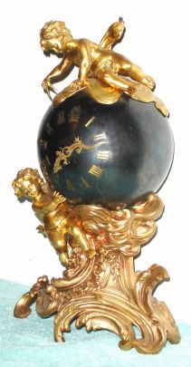 French, ball or globe clock, held aloft by one cherub, and surmounted by a second cherub with a compass in his hands, and with kimoto dragon hands, the head is the hour hand and the tail is the minute handC.1880. — Antique Clocks Price Guide