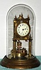 German, Jahresuhrenfabrik, 400 Day mantel clock with porcelain dial and glass dome, disc pendulum, dial signed Urania. C. 1908.