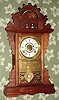Seth Thomas Clock Co., Thomaston, Conn, "ECLIPSE" model, walnut gingerbread clock, time and gong strike, with bell alarm, 8-day, spring, fancy Eclipse pendulum. C.1890.