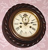 Ansonia Clock Co., "Five Inch Cable", with 8-day double spring time only movement, oak case with carved "cable" surround, and with seconds hand. C.1890,.