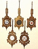Pendulums, lot of 5 (five), Welch cast pends: two for Eclipse, and 2 for Pattis, first 4 with sandwich glass inserts, and a 5th with a hard rubber insert, with ENWCo logo molded in. C.1880.