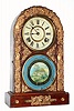 Japanese, Aichi Clock Co., 8-day shelf clock for the Asian market, with cast gesso dragons and gargoyles applied to the door, painted gold. C.1910.
