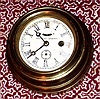Waterbury Clock Co., 4 Inch Lever Timepiece, in a spun brass case with wooden back, 30-hour. C.1890.