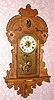 Seth Thomas Clock Co., KING BEE, oak cased hanging gingerbread clock, time, strike and alarm, 8-day. Manufactured by Seth Thomas for the L. B. Price Co of Kansas City. C.1912.