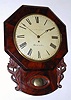 English, Single Fusee, Octagon drop wall clock in mahogany, 8-day, with carved accents; rt hand access door for pendulum. C.1870.