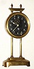 French, Gravity Clock, 1-Day, with exposed compound pendulum visible through the glass dial; movement in a brass canister that is raised on toothed upright to wind. C.1922.