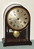German, M. Winterhalder and Hofmeier, Neustadt, Baden, unusual mahogany and beveled glass quarter striking regulator, with silvered dial and neat curved glass that continues clear around the top. 8-day. C.1900