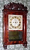 C.1830, Spencer, Hotchkiss and Co., Salem Bridge shelf clock, in a mahogany veneered case with pilasters, Corinthian capitals and a well carved fruit bowl splat and paw feet.