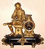 French, S. Marti, large figural clock, black marble base with patinated spelter statue of a seated artist, and with black dial, gilt bronze applied numerals, and open escapement. C.1890