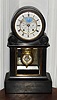 French, Black marble mantel clock with day and date calendar plus moon-phases on the dial, pat A. Brocot and Dellettrez, signed on movement and dial below 6, C.1890