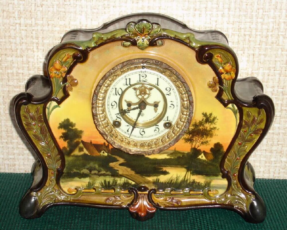 Ansonia Clock Co., C.1900, Royal Bonn, "LA RITA" porcelain china cased clock, with 8-day, gong strike mov't with open escapement on porcelain dial, special order with hand painted country cottage by brook. — Antique Clocks Price Guide