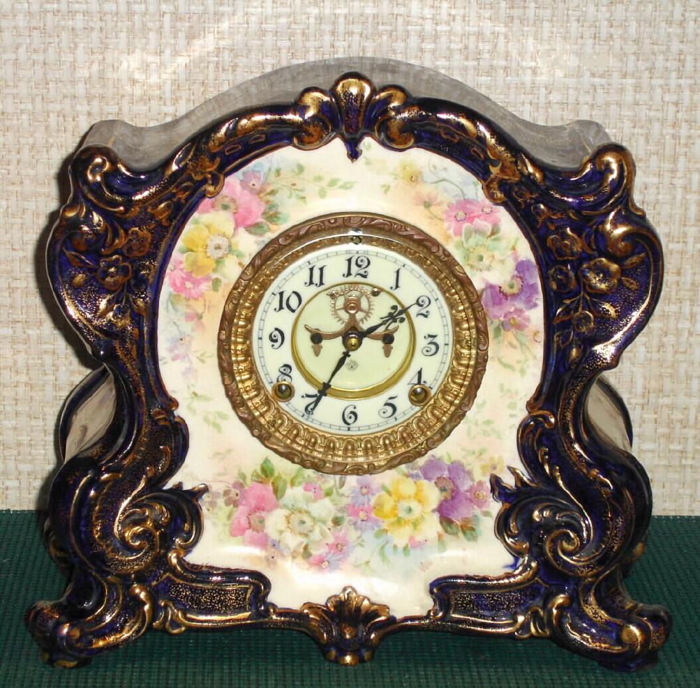 Ansonia Clock Co., C.1915, Royal Bonn, Blue Cobalt, "LA CANTAL" porcelain china cased clock, with 8-day, gong strike mov't with open escapement on porcelain dial, and with bright gold highlights. — Antique Clocks Price Guide