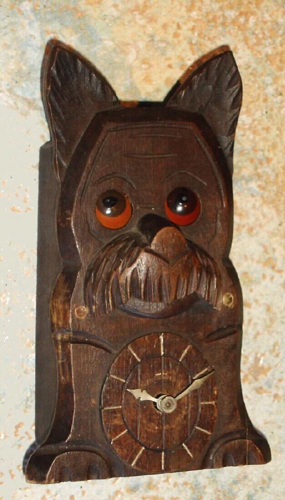 German, Dog Novelty clock, carved face of a dog with eyes that rotate while the clock runs, time shown on lower dial, 1-day back wind, lever mov't, c.1910 — Antique Clocks Price Guide